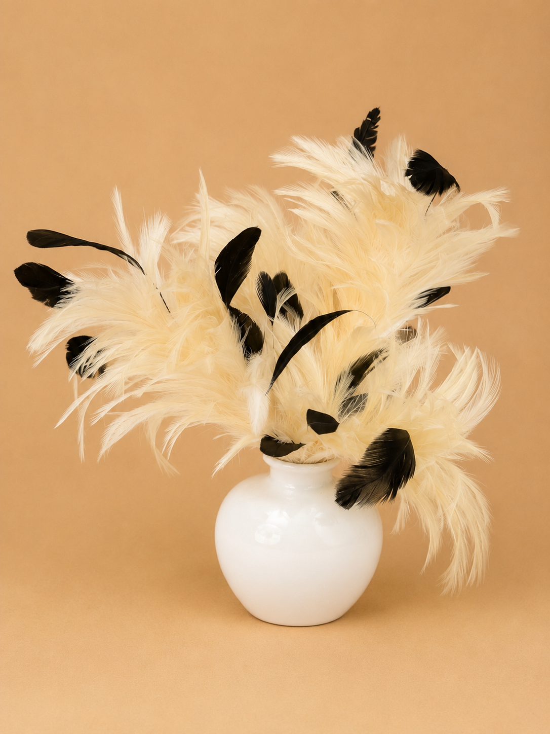 Monochrome Feather Arrangement in White Ceramic Vase
