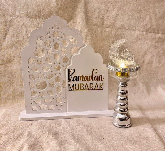 white ramadan sign with silver candle holder