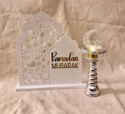 white ramadan sign with silver candle holder