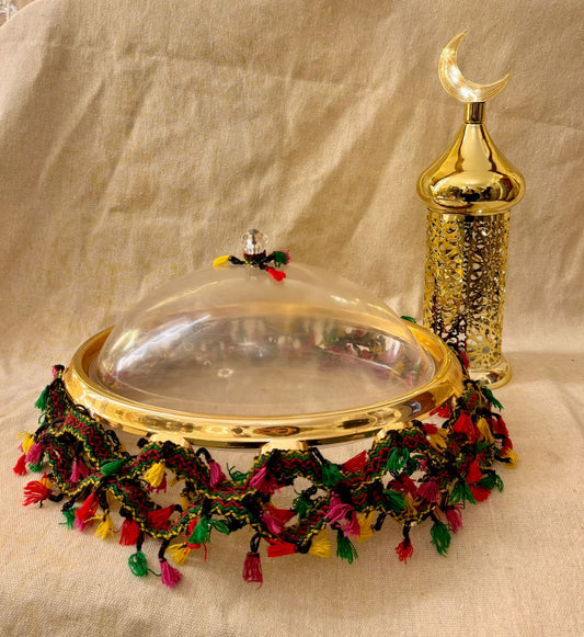 Ramadan tray with green and red tasssles with gold lantern