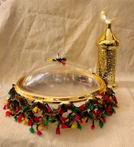 Ramadan tray with green and red tasssles with gold lantern