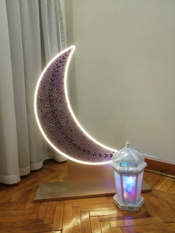 Radiant crescent with glowing white lantern
