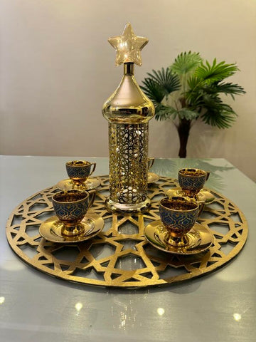 Gold and green coffee cups and plates with gold lantern
