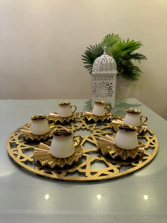 Gold and white coffee cups and plates with large coaster