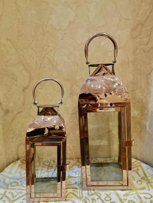 Rose gold lanterns with glass panels and elegant handles