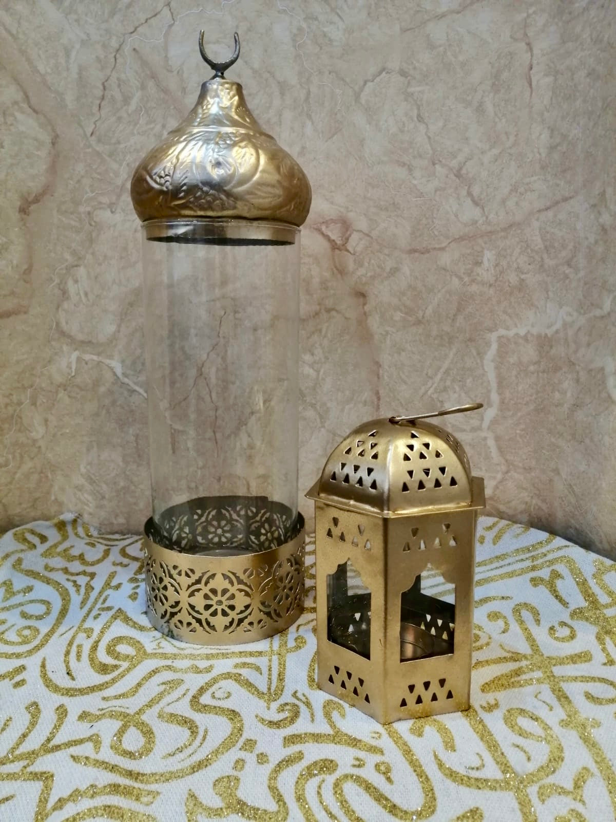 Gold lantern and glass holder with intricate patterns