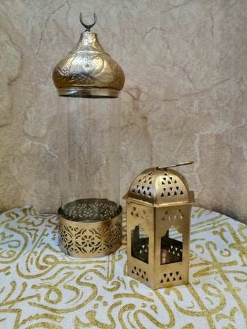 Gold lantern and glass holder with intricate patterns